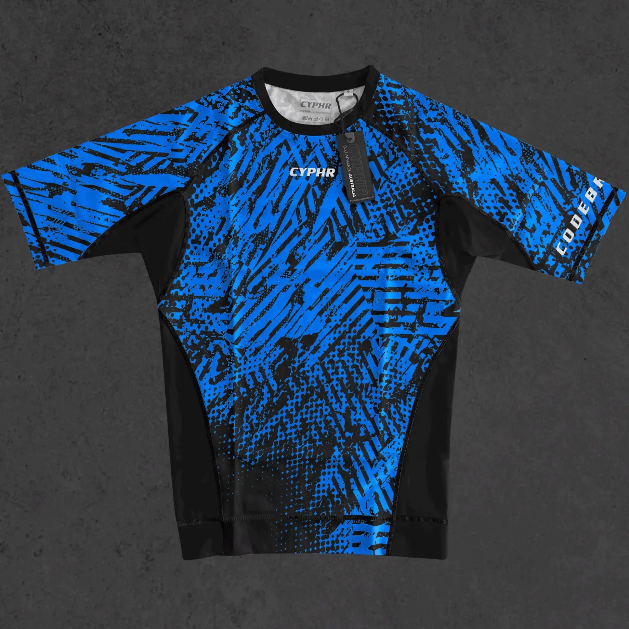 Enigma Series BJJ rash guard by CYPHR Combat in vibrant blue and black design.