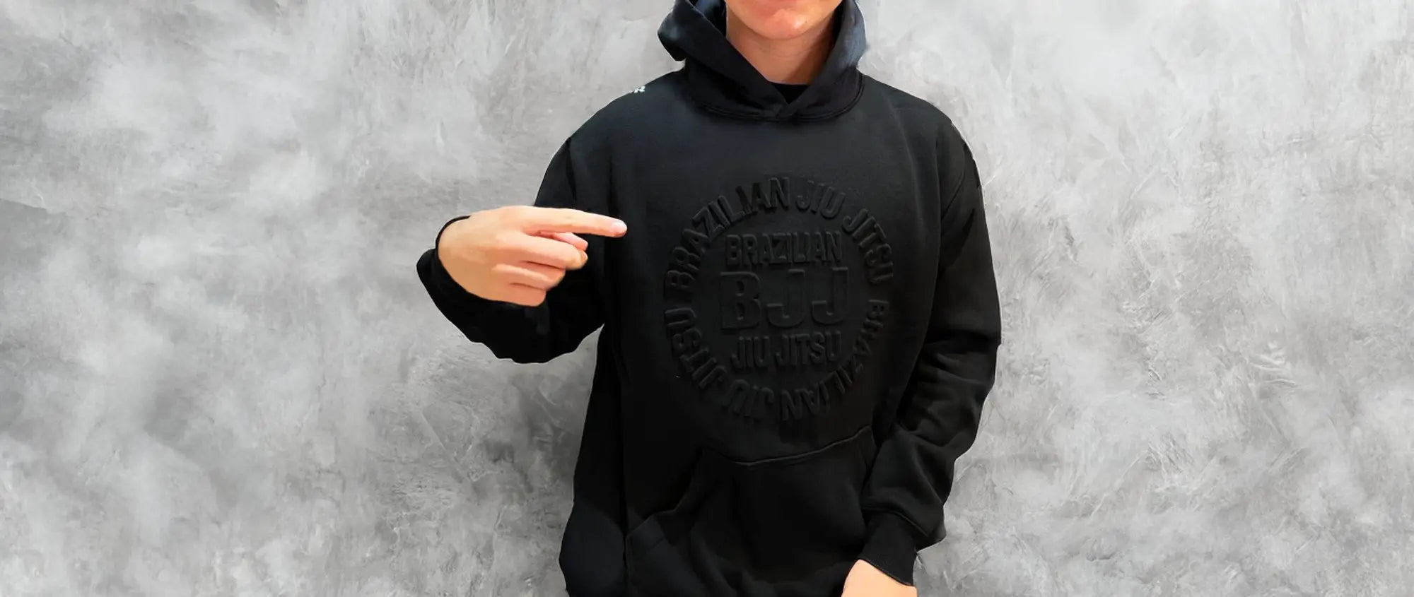 Men's black BJJ hoodie by CYPHR Combat with embossed design, ideal for comfort and style in Brazilian Jiu-Jitsu.