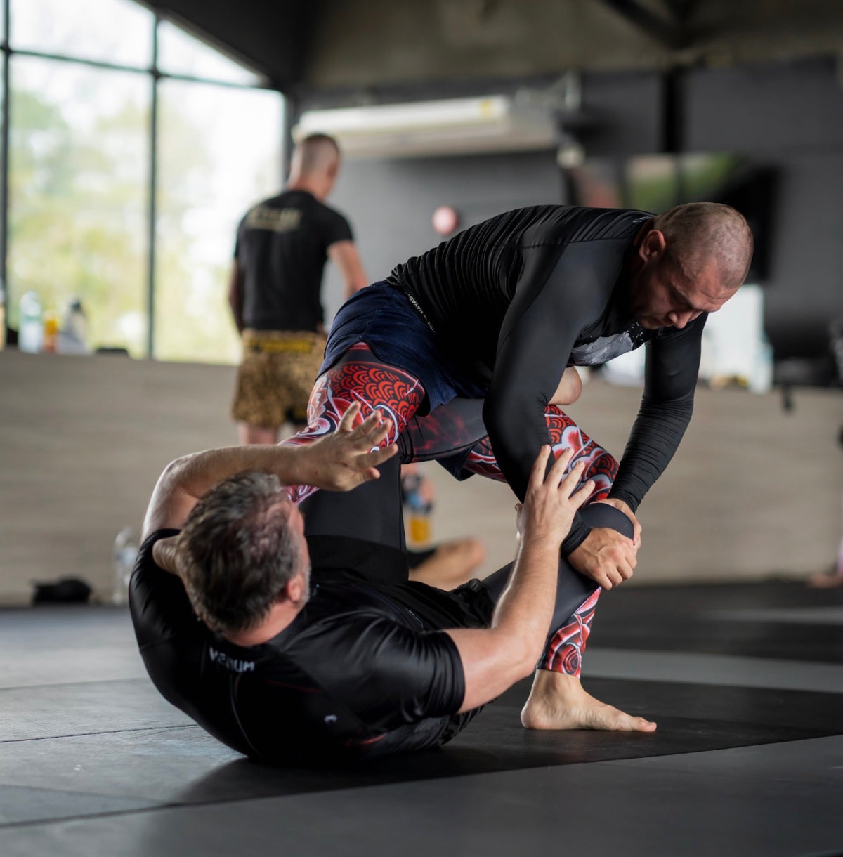 Josh Willis rolling no-gi at a training camp in Thailand