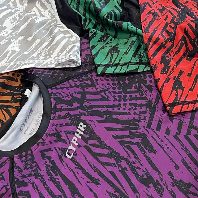 CYPHR Combat rash guards in purple, green and red camo prints