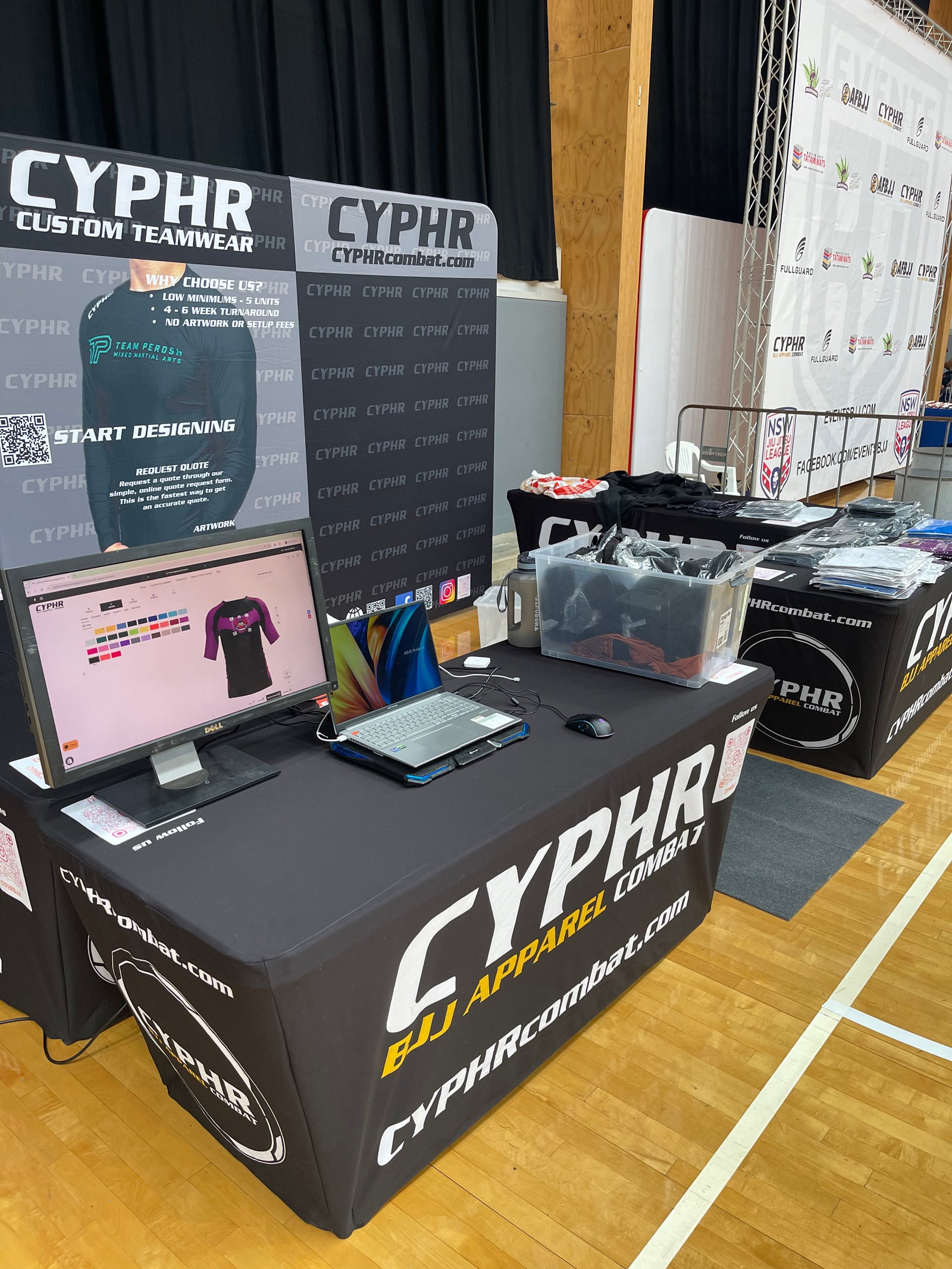 The CYPHR Combat custom teamwear stand at a jiu-jitsu competition