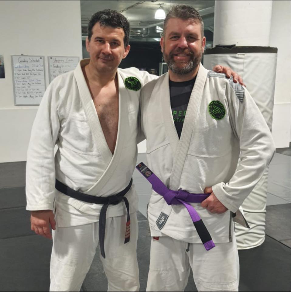 Josh Willis receiving his purple belt from Anthony Perosh