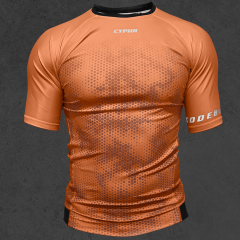 Brown short sleeve BJJ rash guard with hexagon camo, part of the CYPHR Codebreaker Series, designed for top performance.