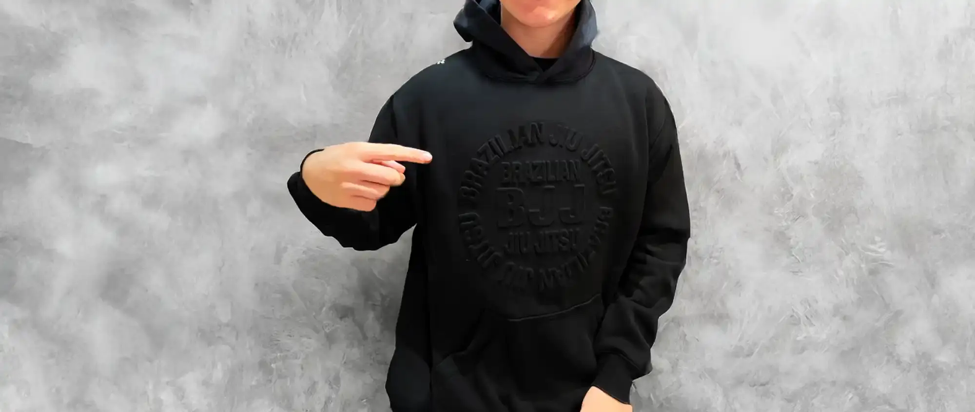 Black hoodie sweatshirt with embossed or tonal design on the front.