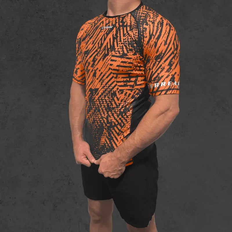 Orange and black Cyphr Combat Rash Guard featuring geometric patterns for BJJ training