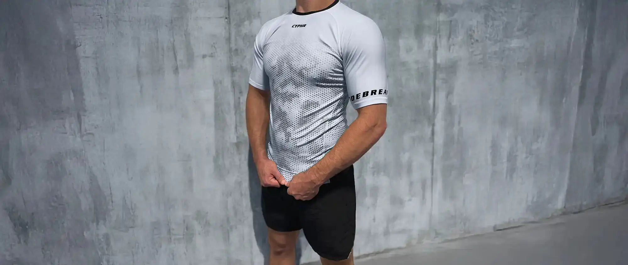 White t-shirt with black athletic shorts worn together as an outfit.